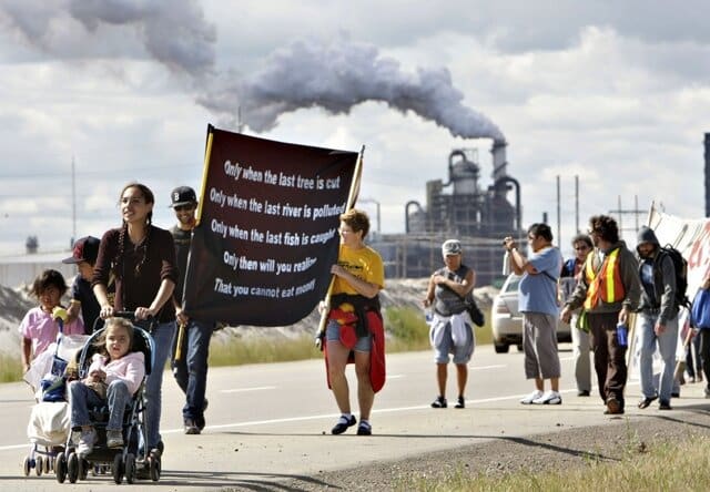 A group of walkers take part in the 13 km Healing Walk past Syncrude and the tailings ponds north of  Fort McMurray on Saturday, August 14 2010. Photo by Keepers of the Athabasca.